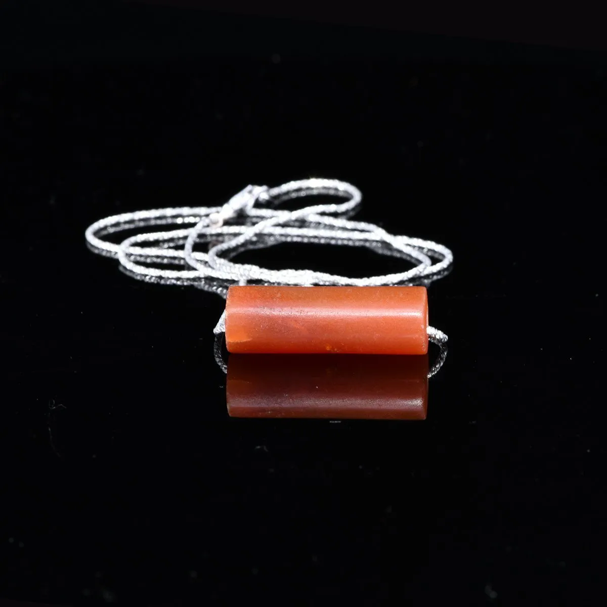 A fine Inca Carnelian Tube Bead, set as a pendant, ca 1400-1560 CE